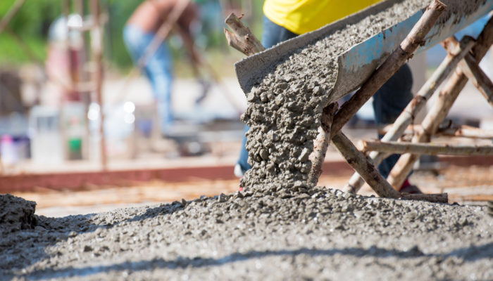 Selective focus of concrete pouring during commercial concreting floors of building Selective focus of concrete pouring during commercial concreting floors of building